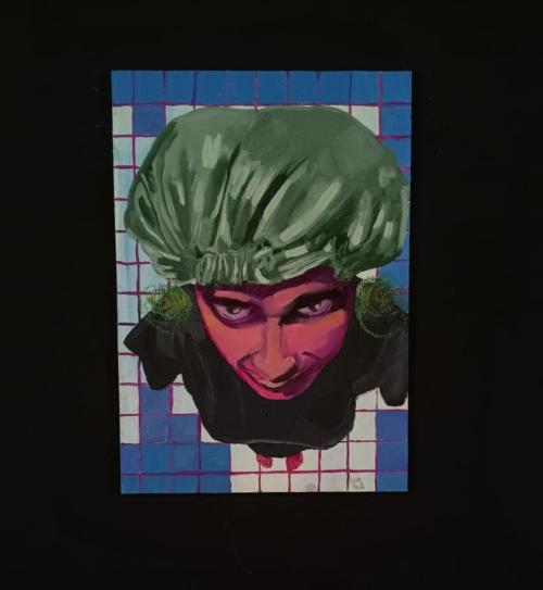 Uma das obras da exposição, da estudante Gabi Cecile, que retrata uma cabeça rosa com uma touca verde saindo de dentro de uma parede quadriculada.