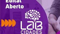 Card do instagram do projeto, nas cores rosa, roxo e laranja com as inscrições "Edital Aberto" e a logo do projeto: bolinhas interligadas com o perfil de um cérebro humano e, abaixo, escrito "Lab Cidades, projetos inteligentes"