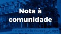 Cartaz com a inscrição Nota à comunidade e uma foto da reitoria ao fundo em tons de azul
